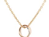 a gold necklace with two inter links on a chain