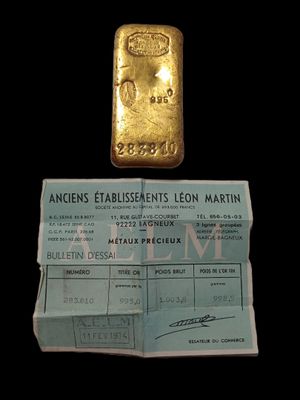 an image of a gold bar next to a passport