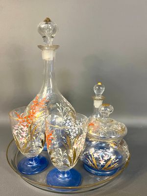 three glass bottles and a tray on a table