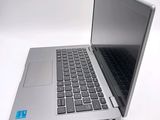 a silver laptop with a black keyboard on a white surface