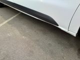 a white truck parked in a parking lot next to a building