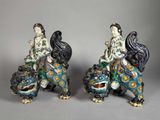 pair of chinese porcelain figurines of a woman and a lion