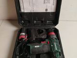 a close up of a box with a cordless drill and other tools