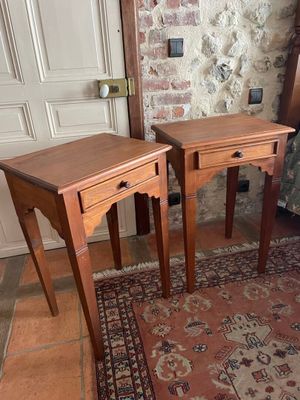 two tables that are sitting on a rug in a room