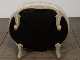a black and white chair sitting on a wooden floor