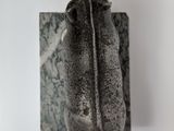 a sculpture of a bird that is hanging on a wall