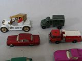 several toy cars are lined up in a row on a white surface
