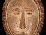an image of a wooden mask on a black background