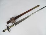 an old sword with a wooden handle on a white surface