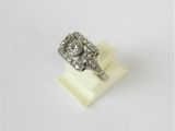 a close up of a diamond ring on a white surface