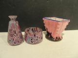 three vases sitting next to each other on a table