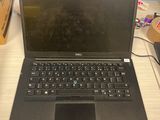 a laptop that is sitting on a desk in front of a window