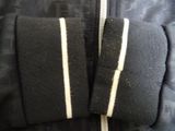 black jacket with white stripes on the sleeves and a zipper