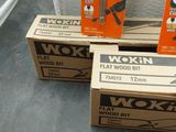 three boxes of wokn wood sit on a table in front of a box of wood