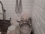a sink with a lot of pots and pans in it
