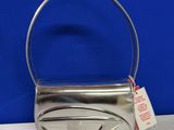 a close up of a silver purse with a tag on it
