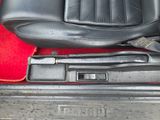 an image of a seat in a car with a red carpet