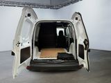 the back of a white van with its doors open in a room