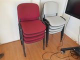 three chairs that are sitting in front of a flat screen tv