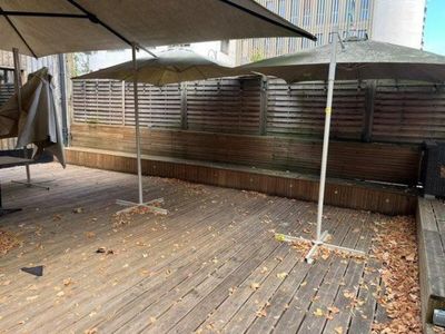 two umbrellas that are sitting on a wooden deck