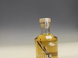 a small bottle of vanilla syrup sitting on a counter