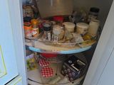 an image of a corner of a kitchen with a lot of food on the shelves