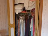 a closet with a lot of clothes in it
