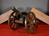 a wooden cart with a wine bottle on top of it