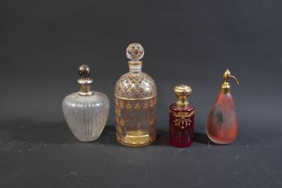 three different colored glass bottles sitting next to each other on a table