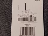 the label on the back of a jacket is attached to a hanger