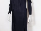 the mannequin is wearing a black dress with long sleeves