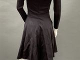 an image of a mannequin wearing a black dress with long sleeves