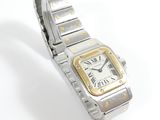a silver and gold wrist watch on a white surface