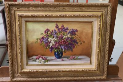 a painting of purple and white flowers in a blue vase on a table