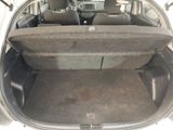the back of a car with its trunk open and the seats folded down