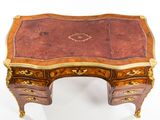 a small desk with a marble top on a white surface