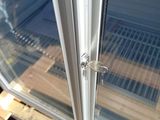 a close up of a glass door with a metal latch