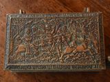 a metal box that has a picture of a man and a dog on it
