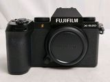 a black camera sitting on a white surface