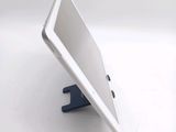 a tablet that is sitting on a stand on a table