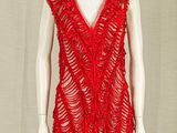 a mannequin with a red top on a stand