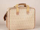 an image of a beige and tan suitcase with a handle
