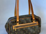 a louis vuitton handbag on a white background