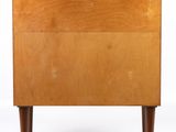 an image of a small wooden cabinet with a drawer underneath it