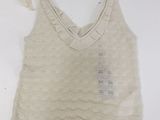 sleeveless top with ruffles on the bottom and a hole in the bottom