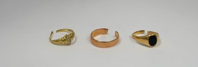 three gold rings and a ring with a black stone