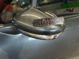 a close up of a car door handle with a sticker on it