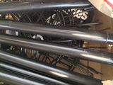 a box full of black metal pipes in a room