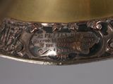 a close up of a brass bell on a table