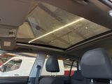 a view of a car ' s sunroof from inside the vehicle